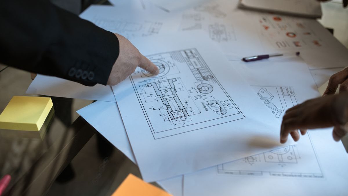 Engineers reviewing a custom motor specification drawing during a design meeting