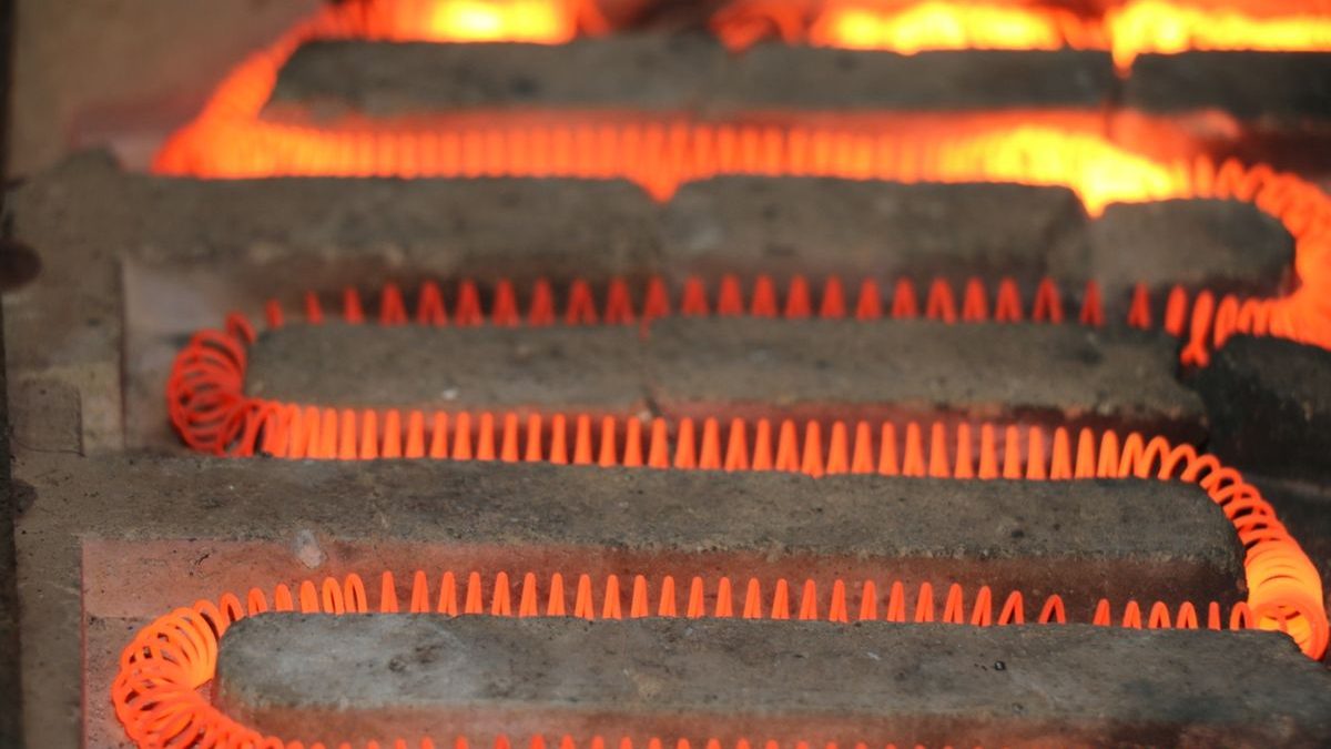 Glowing electric heating elements illustrating thermal limits behind motor insulation classes