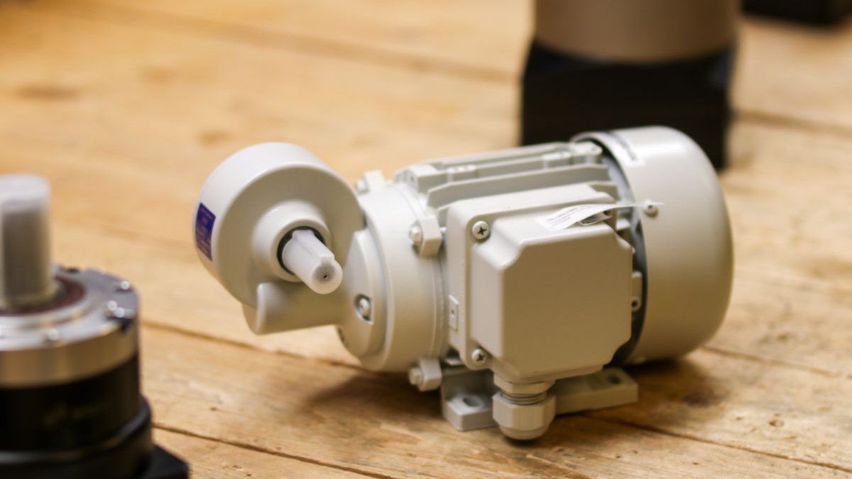 Permanent magnet DC geared motor on a workbench during application selection review